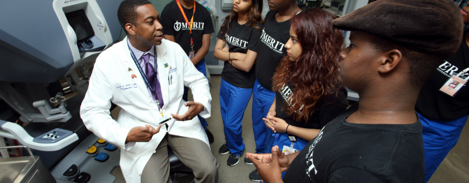 doctor showing students a medical machine